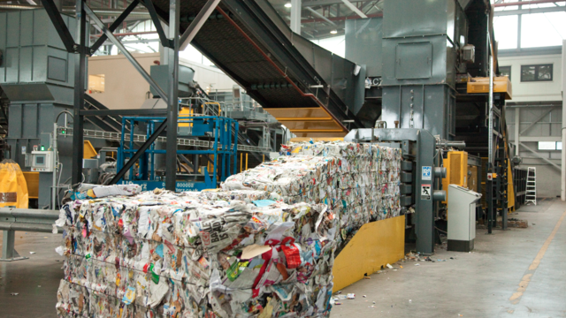 Paper bales being produced by a baler machine at Gillmoss Materials Recovery Facility