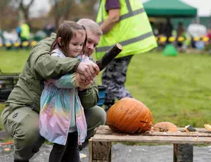 A family taking part in the great pumpkin smash day