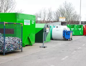 Image showing West Kirby Household Waste Recycling Centre with various different coloured recycling containers, bins and cages
