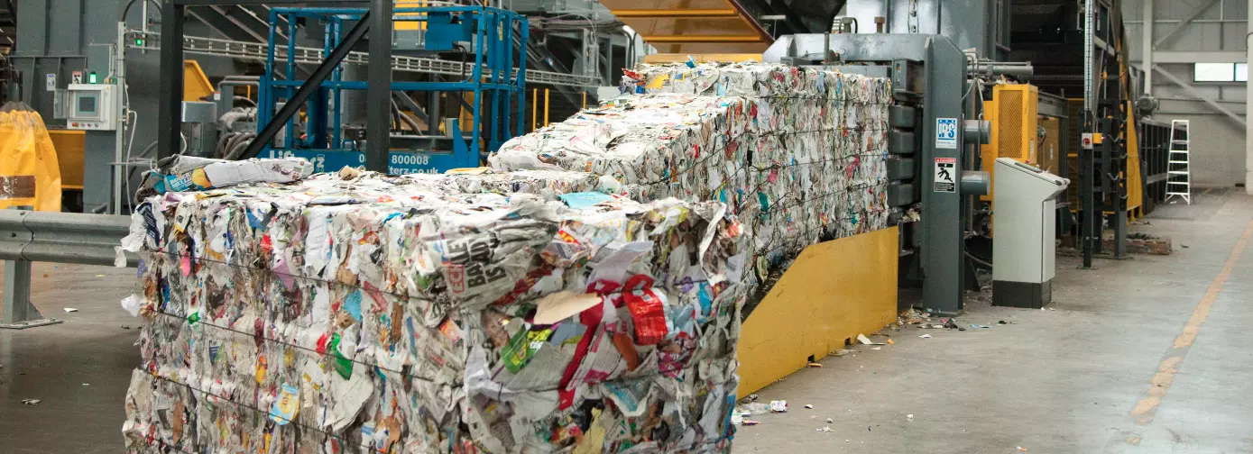 Paper bales being produced by a baler machine at Gillmoss Materials Recovery Facility
