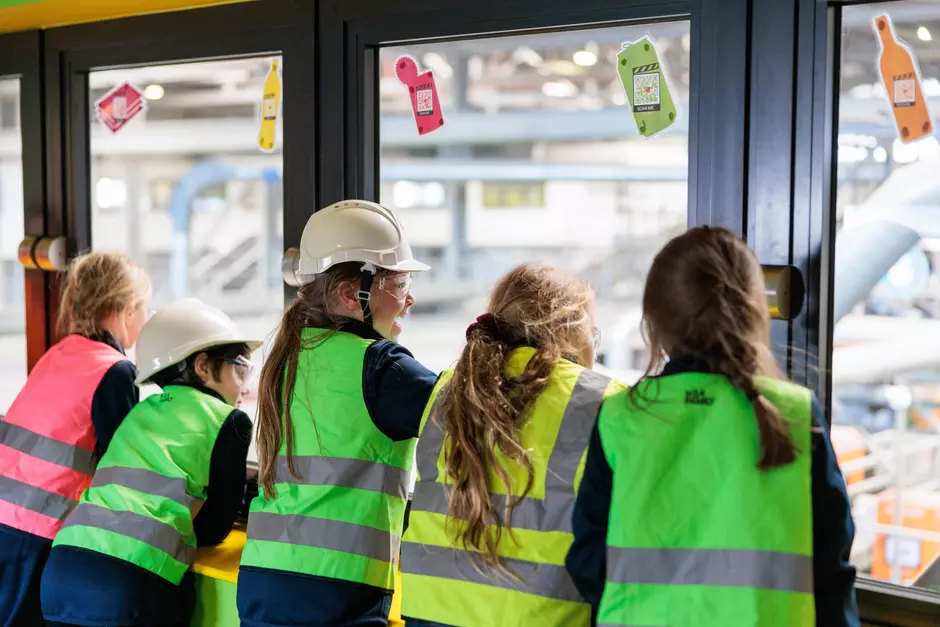 Children looking out through facility windows