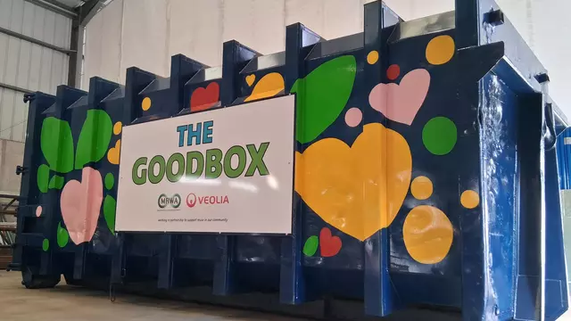 Green shaded border surrounding a blue container painted with pink green and yellow hearts and leaves.