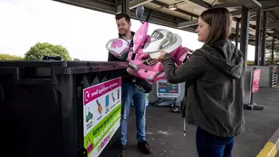 two people recycling electrical items and toys at the recycling centre in Merseyside